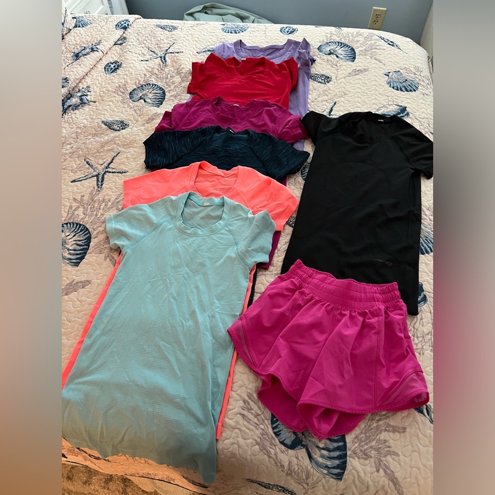 7 Lulu swiftly tech shirts, sizes 0-4. 1 pair 4” shorts. Selling as 1 lot.
